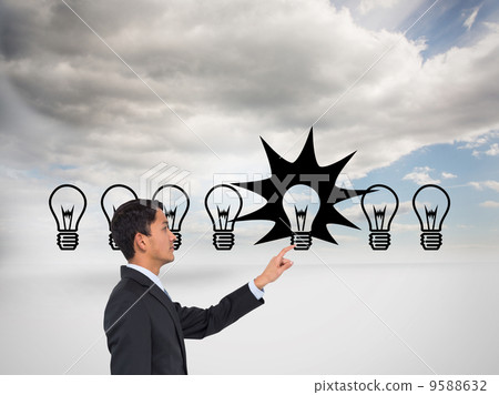 Composite image of stern asian businessman pointing Composite image of stern asian businessman pointing 9588632