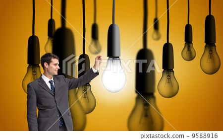 Composite image of smiling businessman holding something up in t Composite image of smiling businessman holding something up in t 9588916