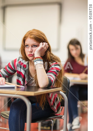 Bored female student sitting in classroom Bored female student sitting in classroom 9589738