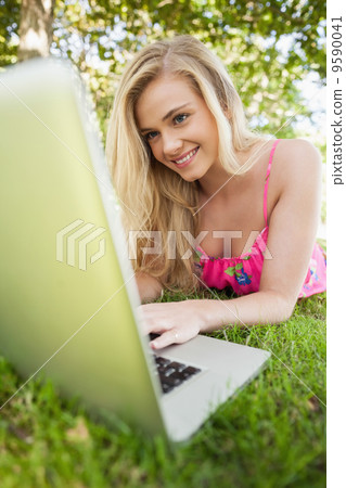 Happy blonde woman using her notebook Happy blonde woman using her notebook 9590041
