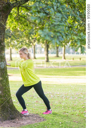 Fit pretty blonde stretching legs Fit pretty blonde stretching legs 9590080