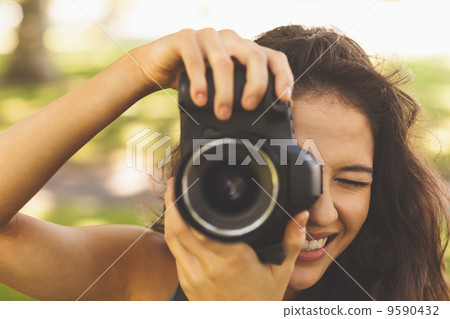 Beautiful brunette woman taking a picture 9590432