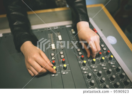Close up of female hands turning up volume 9590923