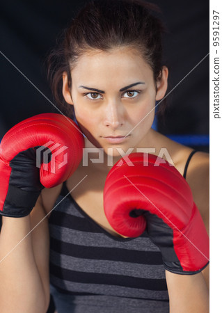 Close-up of a beautiful woman in red boxing gloves Close-up of a beautiful woman in red boxing gloves 9591297