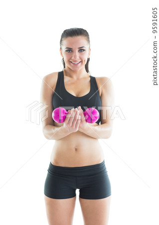 Portrait of happy active woman training using a pink dumbbell 9591605