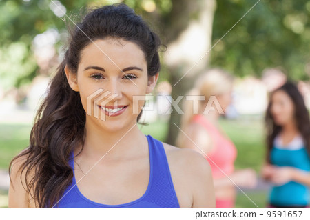 Beautiful sporty woman posing in a park Beautiful sporty woman posing in a park 9591657