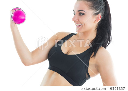 Natural active woman training with pink dumbbells 9591837