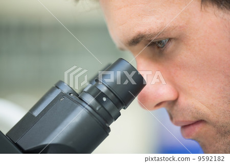 Close-up of a scientific researcher using microscope Close-up of a scientific researcher using microscope 9592182