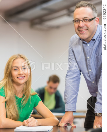 Smiling teacher and student in classroom 9592242