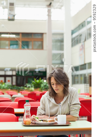 Sad student in the cafeteria with food tray Sad student in the cafeteria with food tray 9592329