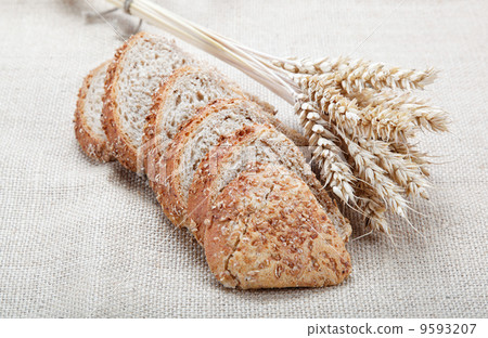 Fresh bread with ears of wheat on the canvas. Fresh bread with ears of wheat on the canvas. 9593207