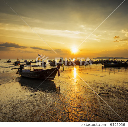 Traditional thai boats at sunset beach. Ao Nang, Krabi province 9595036