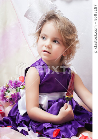 Image of fancy dressed girl posing with lollipop 9595187