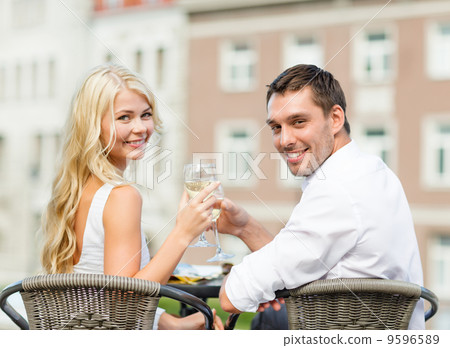 smiling couple drinking wine in cafe smiling couple drinking wine in cafe 9596589