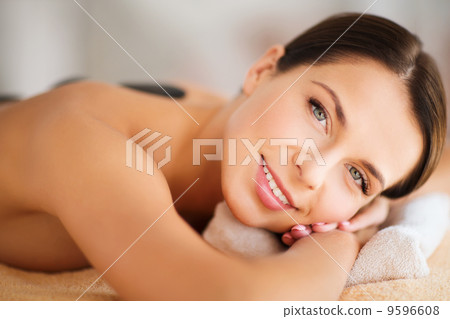 beautiful woman in spa salon with hot stones beautiful woman in spa salon with hot stones 9596608