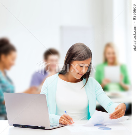 asian businesswoman with laptop and documents asian businesswoman with laptop and documents 9596609