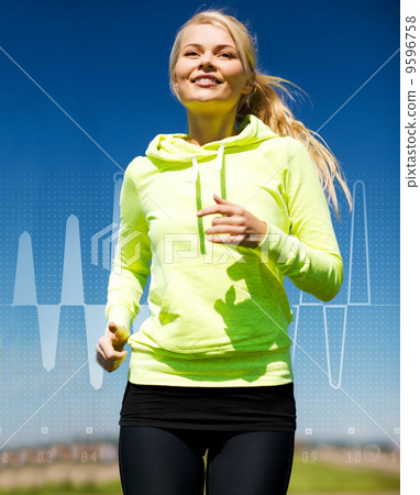 smiling woman jogging outdoors smiling woman jogging outdoors 9596758