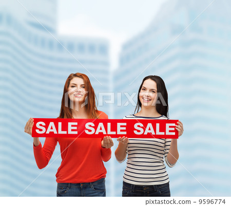 two smiling teenage girl with percent sign on box 9596774