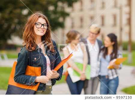 female student in eyglasses with folders 9597130