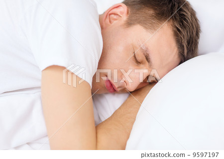 handsome man sleeping in bed handsome man sleeping in bed 9597197