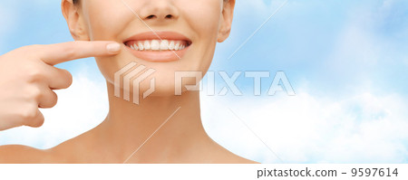 beautiful woman pointing to teeth 9597614