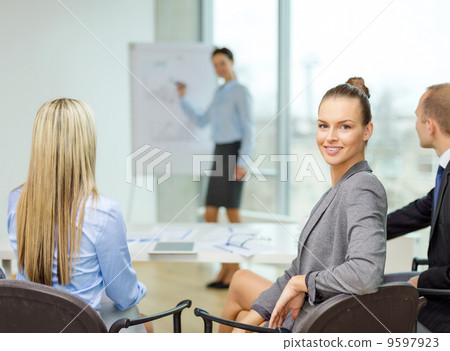 businesswoman with team showing in office businesswoman with team showing in office 9597923