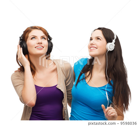 two smiling teenagers with headphones two smiling teenagers with headphones 9598036