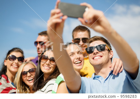 group of friends taking picture with smartphone group of friends taking picture with smartphone 9598283