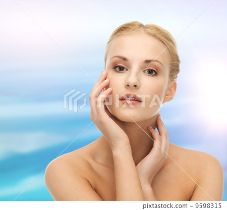 woman touching her face skin 9598315