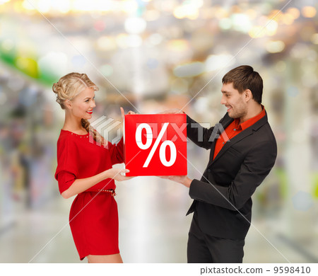 smiling woman and man with red percent sale sign smiling woman and man with red percent sale sign 9598410