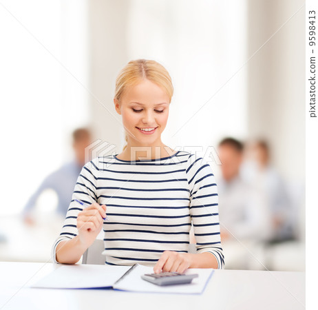 woman with notebook and calculator studying woman with notebook and calculator studying 9598413