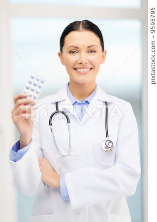 smiling young doctor with pills and sthethoscope smiling young doctor with pills and sthethoscope 9598795