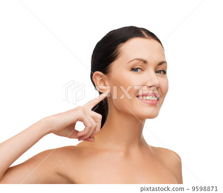 young calm woman pointing to her ear 9598871