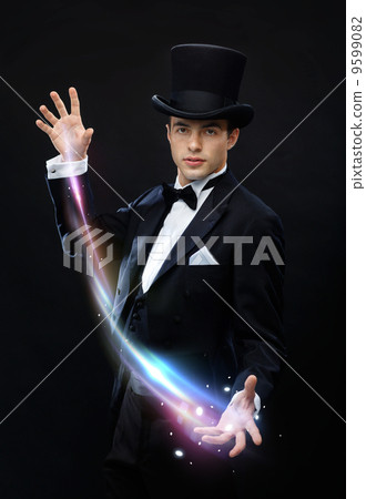 magician in top hat showing trick 9599082