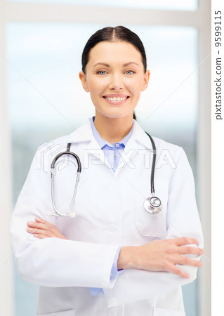 smiling young doctor with stethoscope in cabinet 9599115