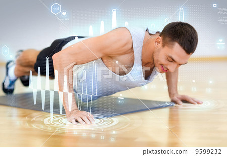 smiling man doing push-ups in the gym smiling man doing push-ups in the gym 9599232