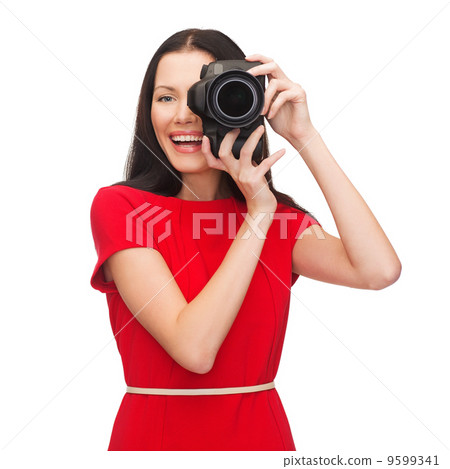 smiling woman taking picture with digital camera 9599341