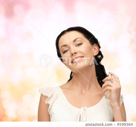 beautiful woman spraying pefrume on her neck 9599364