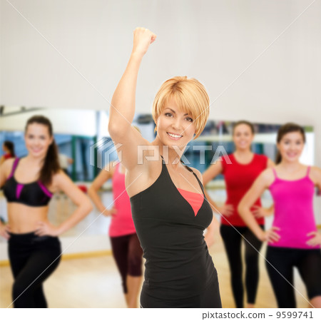 group of smiling people exercising in the gym group of smiling people exercising in the gym 9599741