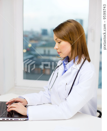busy doctor with laptop computer busy doctor with laptop computer 9599743
