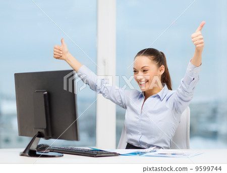 woman with computer, papers showing thumbs up woman with computer, papers showing thumbs up 9599744