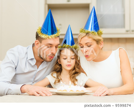 smiling family in blue hats with cake smiling family in blue hats with cake 9599874