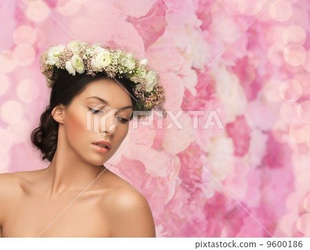 beautiful woman wearing wreath of flowers 9600186
