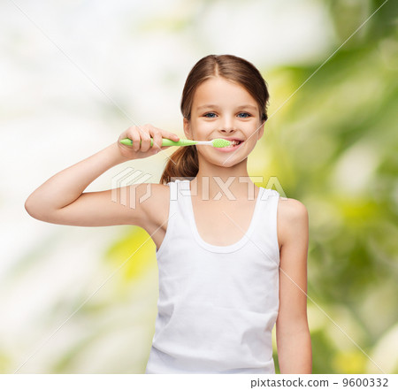 girl in blank white shirt brushing her teeth 9600332