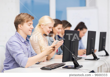 students with computer monitor and smartphones 9600333