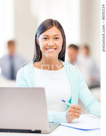 asian businesswoman with laptop and documents 9600334