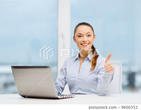 businesswoman with laptop in office businesswoman with laptop in office 9600352