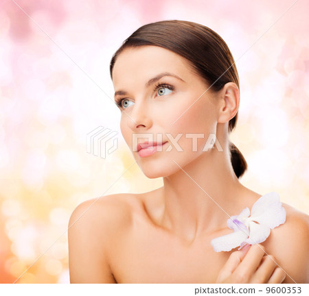 relaxed woman with orhid flower 9600353