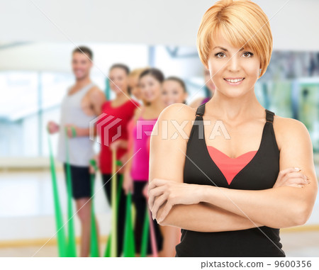 group of smiling people exercising in the gym group of smiling people exercising in the gym 9600356