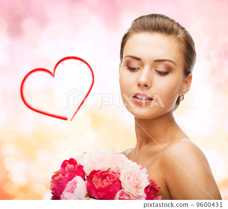 woman wearing earrings and holding flowers woman wearing earrings and holding flowers 9600431